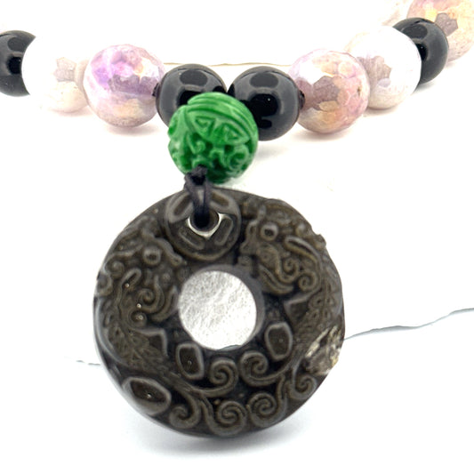 Actual carved obsidian donut and 12 mm carved green jade accent bead close-up