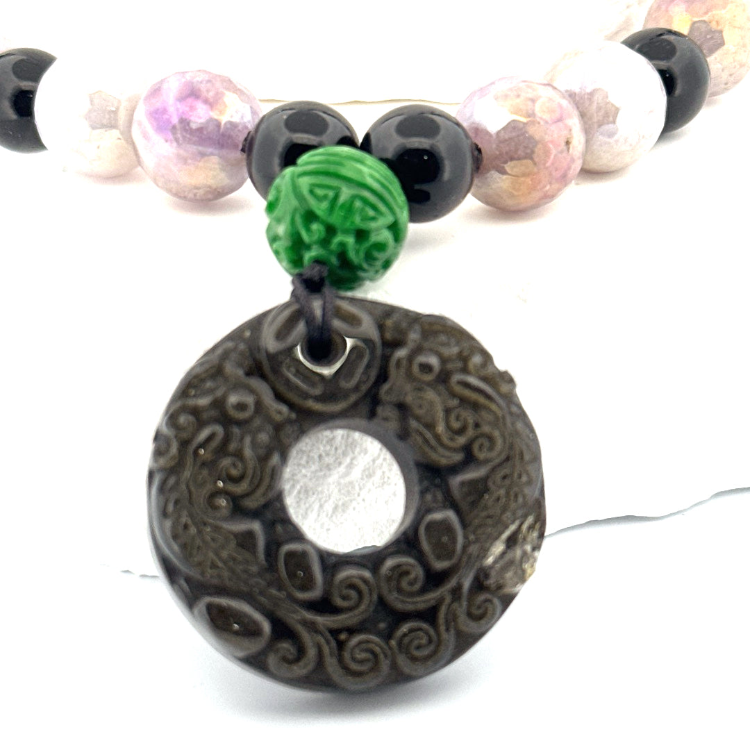 Actual carved obsidian donut and 12 mm carved green jade accent bead close-up